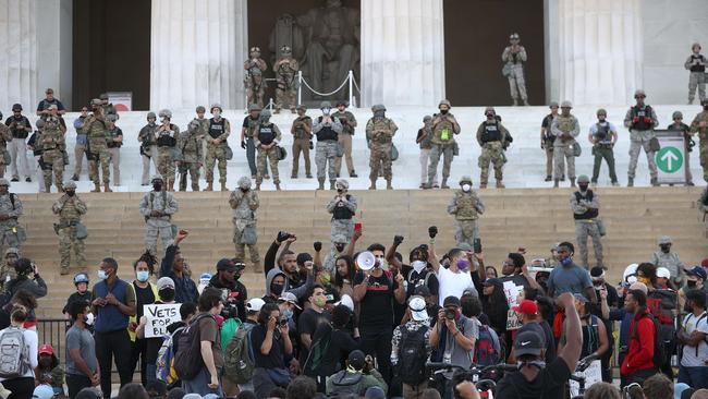 Armed security personnel guard the Lincoln Memorial in Washington as demonstrators continue to protest before the city’s 7pm curfew. Picture: AFP