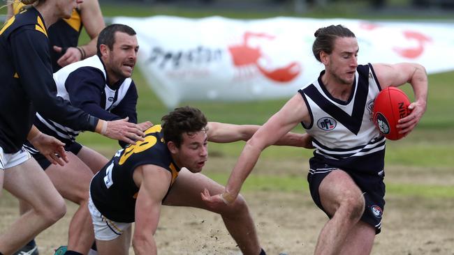 Liam Byrne of Bundoora gathers the ball from a pack during the NFL football match between Bundoora and Whittlesea played at Yulong Park Bundoora on Saturday 4th August, 2018.