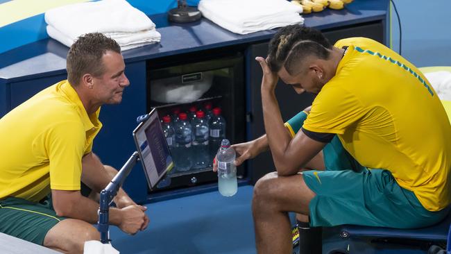 Nick Kyrgios melts down, with Lleyton Hewitt trying to get him back on track. Picture: AAP