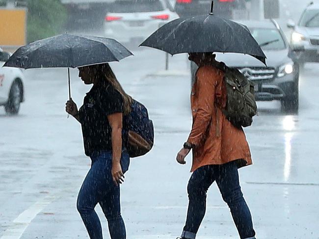 Pedestrians with umbrellas during wet weather in Brisbane, Teneriffe. Photographer: Liam Kidston.