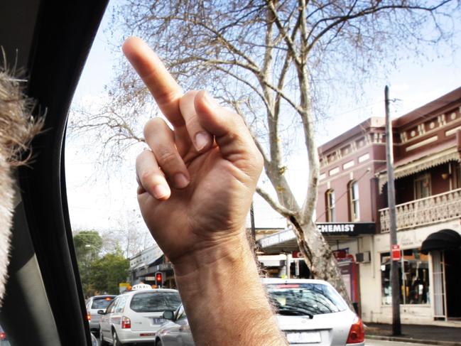 NEWS: Generic pic of a motorist inside his car as he flashes his middle finger at passing vehicles. road rage