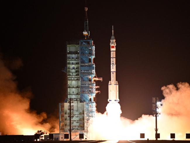 A long March-2F carrier rocket carrying the Shenzhou-19 spacecraft and crew of three astronauts lifts off from the Jiuquan Satellite Launch Center, in the Gobi desert, northwest China, on October 30, 2024. The mission of three astronauts to the Tiangong space station will carry out experiments with an eye to the space programme's ambitious goal of placing astronauts on the Moon by 2030 and eventually constructing a lunar base. (Photo by ADEK BERRY / AFP)