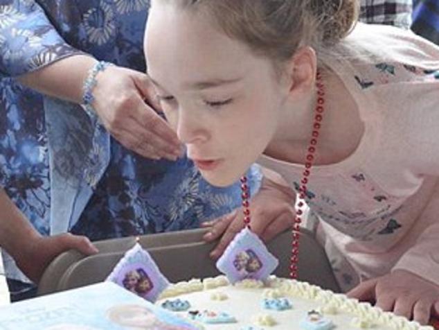 A very special birthday after all ... Mackenzie Moretter blows out the candles on her 10th birthday cake in front of about 300 strangers. Picture: Mackenzie's Birthday Party / Facebook