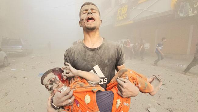 A man carries an injured Palestinian child at Jabalia refugee camp in Gaza City. Picture: Getty Images