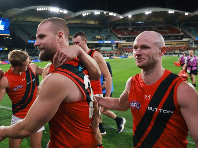 ADELAIDE, AUSTRALIA - APRIL 19: Jake Stringer and Nick Hind of the Bombers celebrate their win during the 2024 AFL Round 06 match between the Adelaide Crows and the Essendon Bombers at Adelaide Oval on April 19, 2024 in Adelaide, Australia. (Photo by James Elsby/AFL Photos via Getty Images)