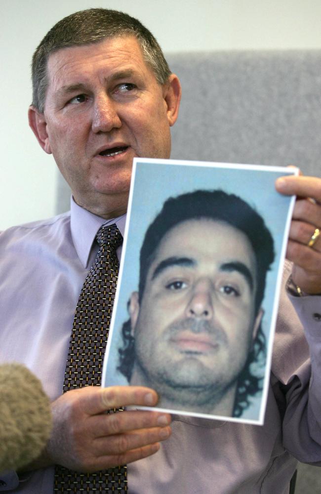 Acting Detective Inspector Nev Huth with a released shot of Yassar Bakir who was accused of the shooting at the Spit, though charges were eventually dropped. Picture: Jono Searle