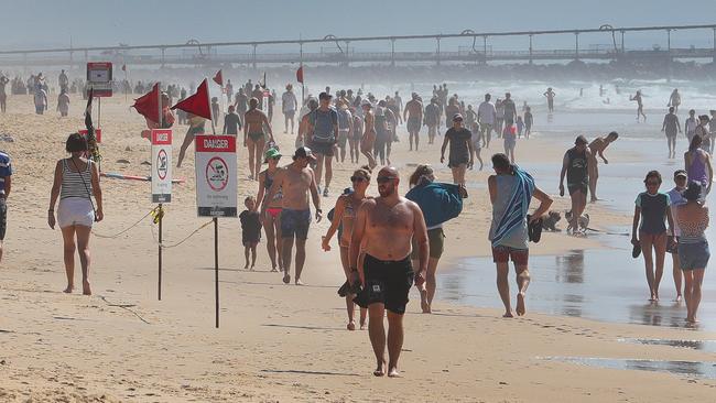 Social distancing fail: people out and about on the Gold Coast’s Spit, seemingly oblivious to the closed carparks and numerous warning signs. Picture: Glenn Hampson