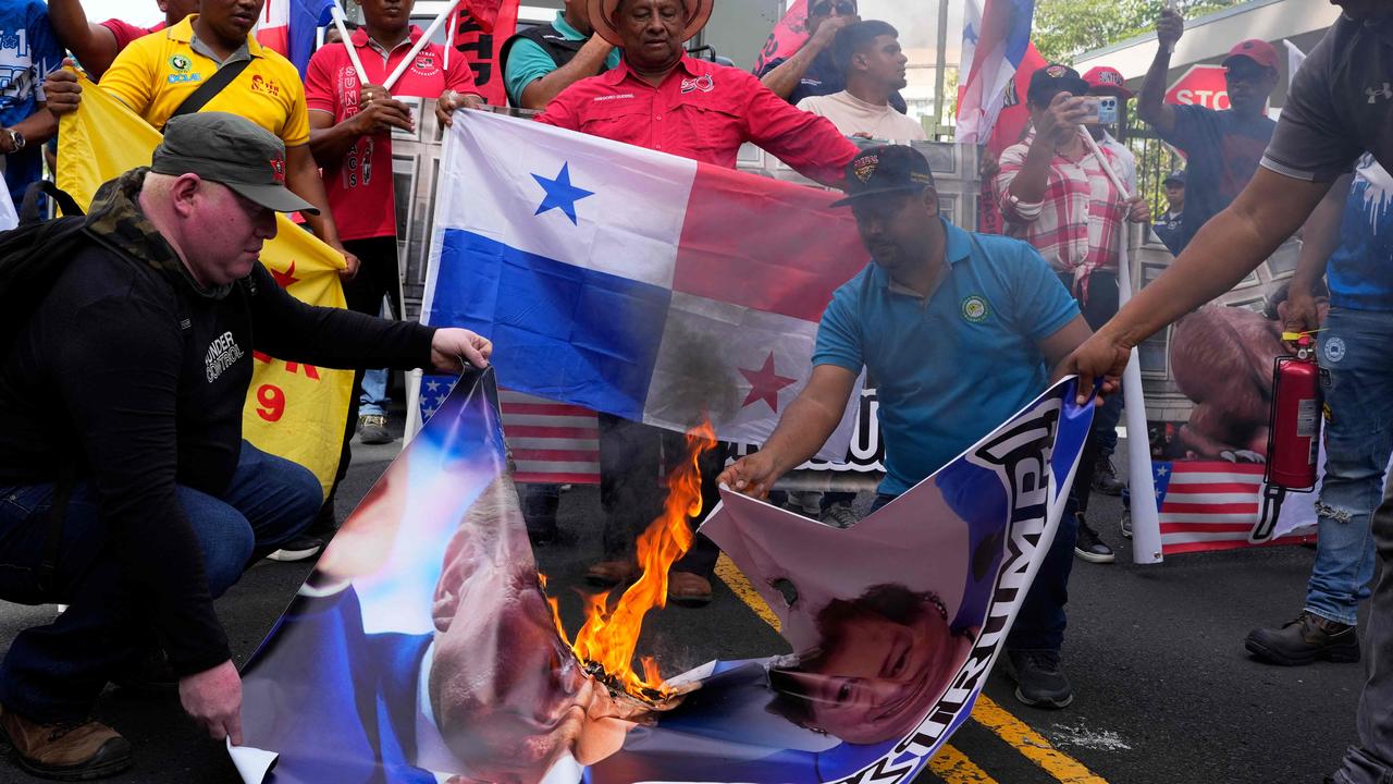 Demonstrators burn a banner with the image of US President-elect Donald Trump during a protest outside the US embassy in Panama City. Picture: ARNULFO FRANCO / AFP)