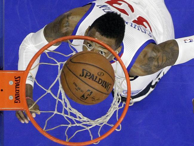 76ers' Robert Covington watches his shot fall into the basket.