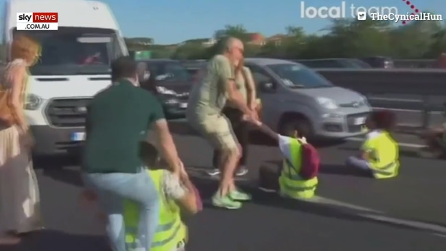 Frustrated motorists have clashed with environmental activists who blocked a busy motorway during a demonstration in Rome on Thursday. Picture: Supplied.