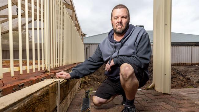 Keith Diener after paying Adelaide Exposed Concrete to repair a retaining wall and re-landscape his lawn. Pictures: Ben Clark