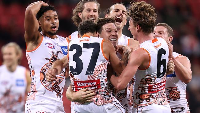 Greene is congratulated after kicking his monster barrel for a goal right on quarter-time. Picture: Getty Images