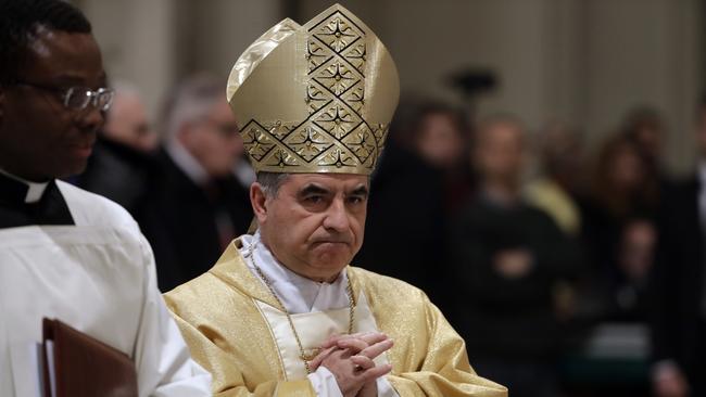FILE - Mons. Angelo Becciu presides over an eucharistic liturgy, at the St. John in Latheran Basilica, in Rome, Feb. 9, 2017. (AP Photo/Gregorio Borgia, File )