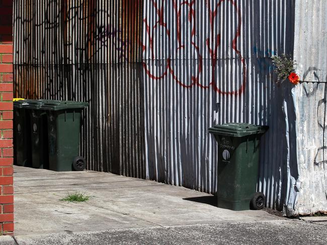 Flowers have been tucked into the corrugated wall that lines one half of the lane way off Hope street in Brunswick where Jill Meagher was attacked.