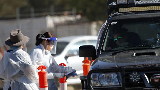 Queensland Health workers test locals for coronavirus. Picture: Steve Vit