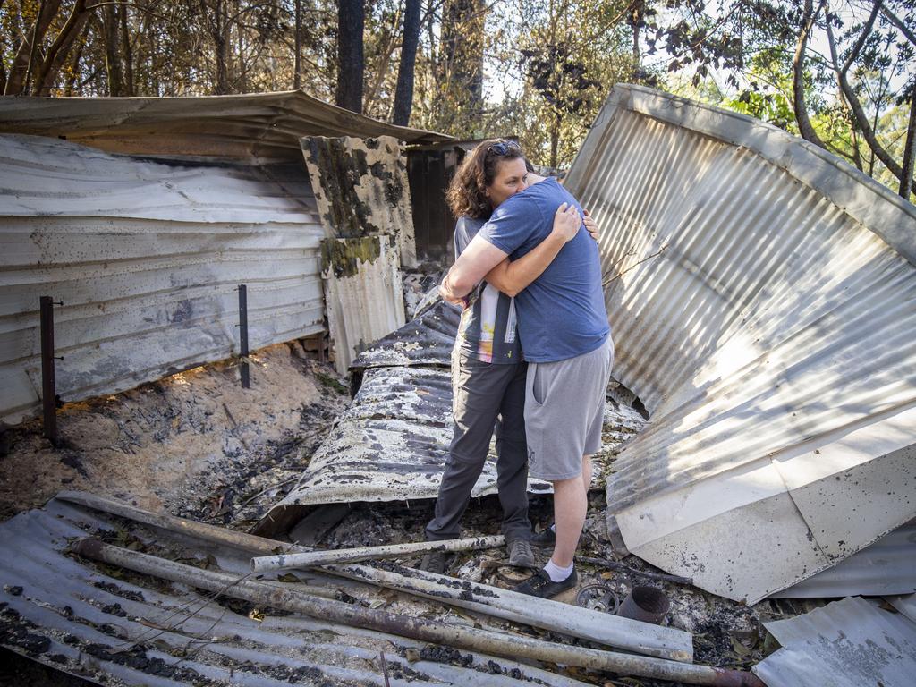 Lisa Groom and her son Luke Beyer stand in the wreckage of a shed on their property. Picture: AAP.