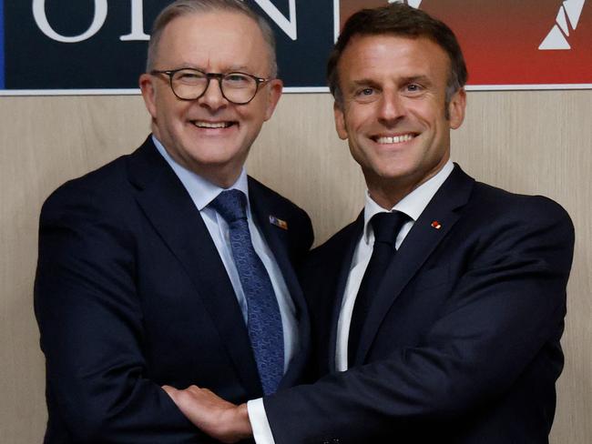 Australian Prime Minister Anthony Albanese (L) shakes hands with French President Emmanuel Macron on the sidelines of the NATO summit, in Vilnius on July 11, 2023. NATO leaders will grapple with Ukraine's membership ambitions at their summit on July 11, 2023, their determination to face down Russia boosted by a breakthrough in Sweden's bid to join the alliance. (Photo by Ludovic MARIN / AFP)