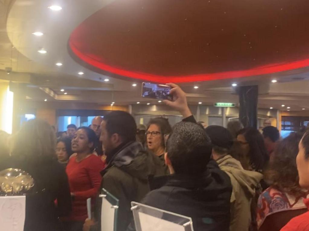 Footage shows hundreds of passengers protesting in the ship's grand atrium amid chants of ‘shame on you’, ‘we want refunds’ and ‘get us off this ship’.