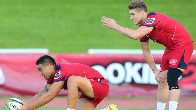 James O'Connor offers some advice to Duncan Paia-aua during a Reds training session.