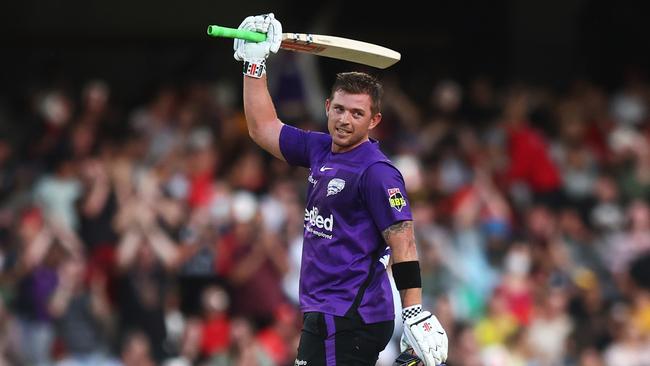 MELBOURNE, AUSTRALIA - DECEMBER 29: Ben McDermott of the Hurricanes raises his bat after scoring a century during the Men's Big Bash League match between the Melbourne Renegades and the Hobart Hurricanes at Marvel Stadium, on December 29, 2021, in Melbourne, Australia. (Photo by Mike Owen/Getty Images)