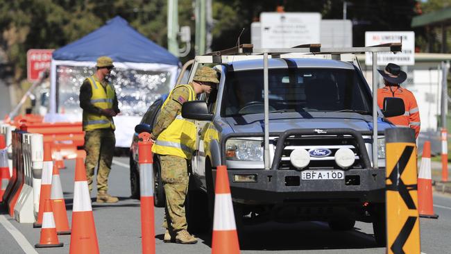 Australian Defence Force personnel assist Queensland police at the Miles St checkpoint. Picture: Scott Powick.