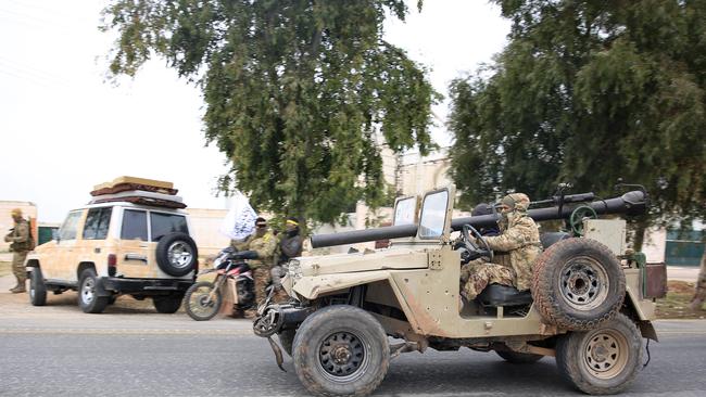 Anti-government forces drive through the city of al-Rastan in Syria's province of Homs on Saturday on their way to Homs. Picture: AFP