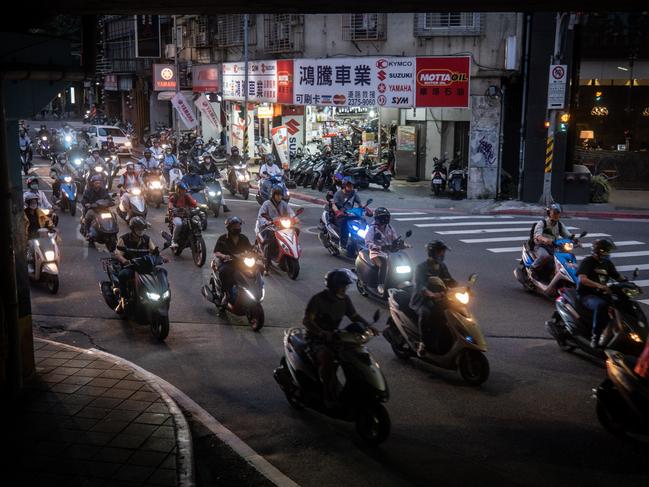 TAIPEI, TAIWAN - APRIL 18: People ride scooters during peak hour on April 18, 2023 in Taipei, Taiwan. (Photo by Chris McGrath/Getty Images)