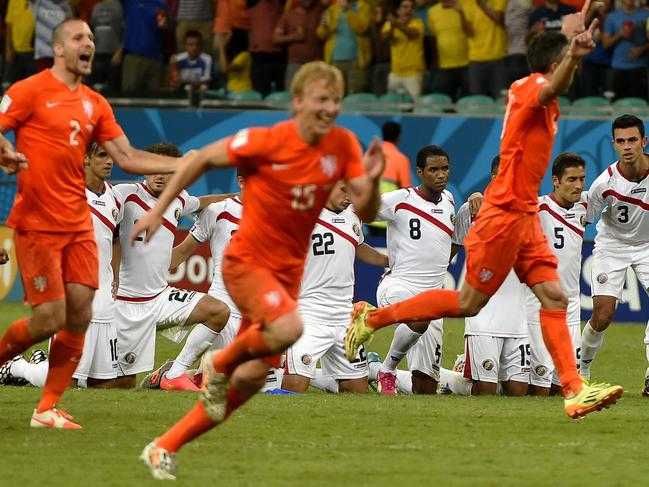 Netherlands' footballers celebrate after defeating Costa Rica during the penalty shootout after the extra time in the quarter-final football match between Netherlands and Costa Rica at the Fonte Nova Arena in Salvador during the 2014 FIFA World Cup on July 5, 2014. AFP PHOTO / FABRICE COFFRINI