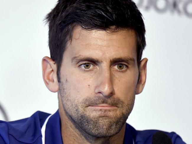 FILE - In this Wednesday, July 26, 2017 file photo, tennis player Novak Djokovic pauses during a press conference in Belgrade, Serbia. Novak has withdrawn from the Mubadala WTC exhibition event due to pain in his right elbow. The Serbian star was scheduled to return to tennis on Friday, Dec. 29, 2017 after being out of the game for nearly six months.(Andrej Isakovic, Pool Photo via AP, File)