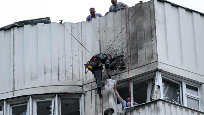 A specialist inspects the damaged facade of a multi-storey apartment building after a reported drone attack in Moscow this week. Picture: AFP.