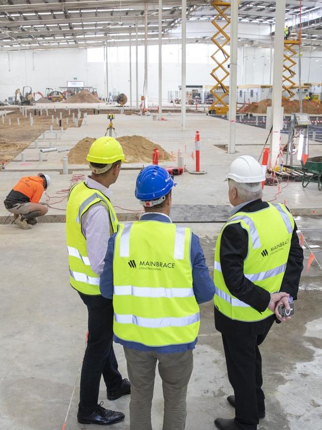 Workers inspect the site of the full-line Woolies. Picture: Dallas Kilponen/Woolworths