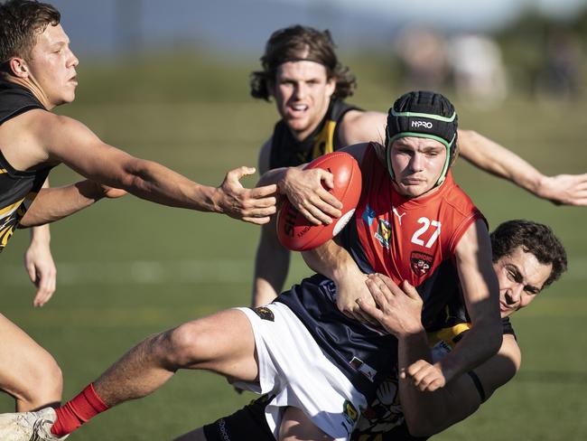 North Hobart’s Angus Norton is brought down by Tigers’ Micah Reynolds. Picture: Eddie Safarik