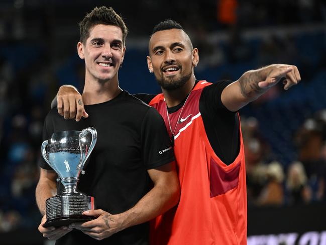 MELBOURNE, AUSTRALIA - JANUARY 29: Thanasi Kokkinakis (L) of Australia and Nick Kyrgios of Australia pose with the championship trophy after winning their Men's DoublesÃÂ Final match against Matthew Ebden of Australia and Max Purcell of Australia during day 13 of the 2022 Australian Open at Melbourne Park on January 29, 2022 in Melbourne, Australia. (Photo by Quinn Rooney/Getty Images)