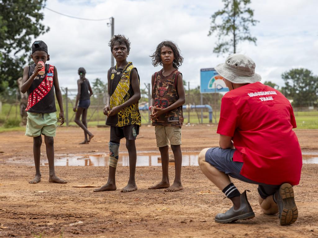 NT Health nurse Aydan Boscheinen speaks to Wurrumiyanga kids about getting the vaccine. Picture: Floss Adams.