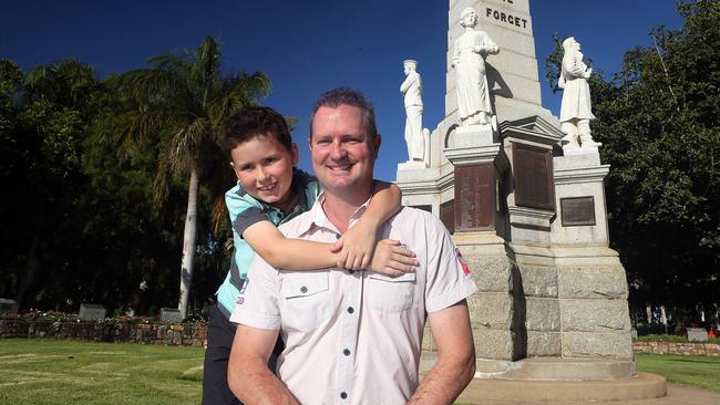 Lt Duncan Chapman’s great great nephew Riley Cook, 8, with father Fraser in front of the Marybrough Centataph. Pic: Glenn Barnes