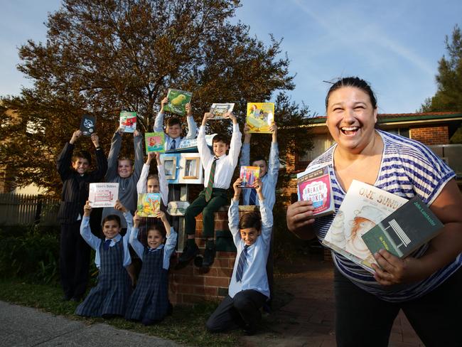 Nina Martelli has several reasons to be happy that her free reading service has taken off so well in Kellyville. Pictures: Peter Kelly.