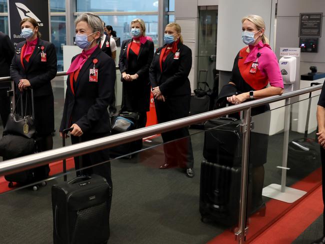 SYDNEY, AUSTRALIA - NewsWire Photos NOVEMBER 23, 2020: Qantas flight crew pose for a picture before they board flight QF409 to Melbourne from Sydney Airport. Borders open between Victoria and New South Wales today. Picture: NCA NewsWire / Damian Shaw