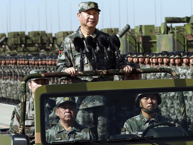 Chinese President Xi Jinping stands on a military jeep as he inspects troops of the People’s Liberation Army during a military parade to commemorate the 90th anniversary of the founding of the PLA last week. Picture: Li Gang/Xinhua/AP