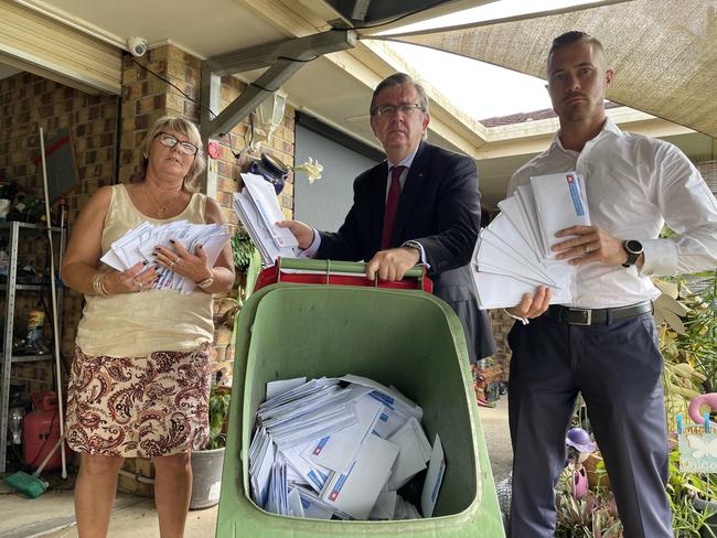 Annette Weller with Senator Paul Scarr and LNP candidate for Blair Sam Biggins with the dumped mailers.