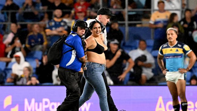 Javon Johanson led away by security guards during the round five NRL match between the Gold Coast Titans and the Parramatta Eels at Cbus Super Stadium. Picture: Bradley Kanaris/Getty Images