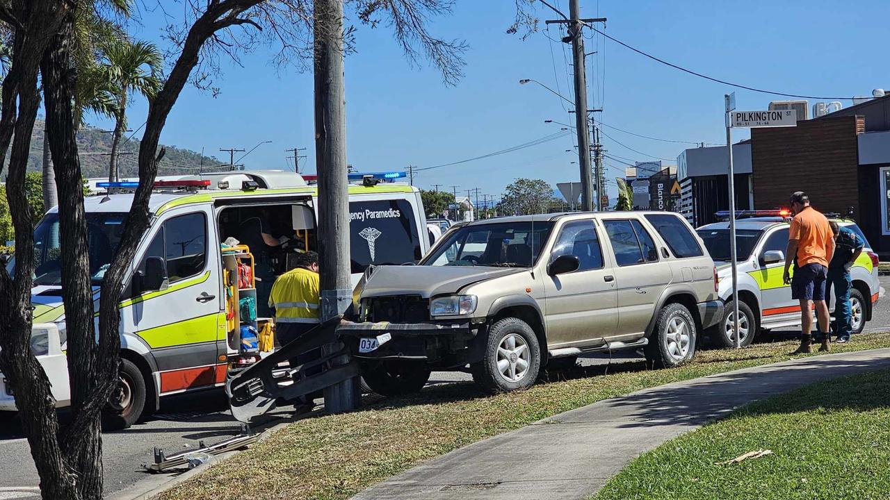 Paramedics assist man after Garbutt crash into pole | The Advertiser