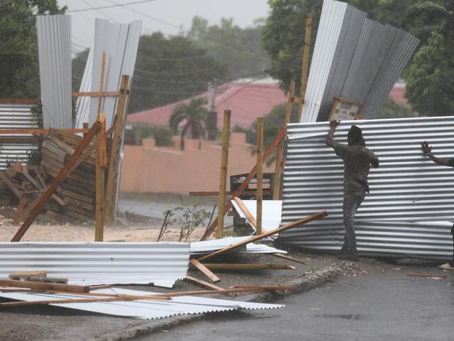 Workers battle high winds as Hurricane Beryl hits Kingston, Jamaica. Picture: Getty Images