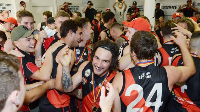 Playing-coach Alex McKay celebrates with Tea Tree Gully players after their premiership win in 2018. Picture: Brenton Edwards