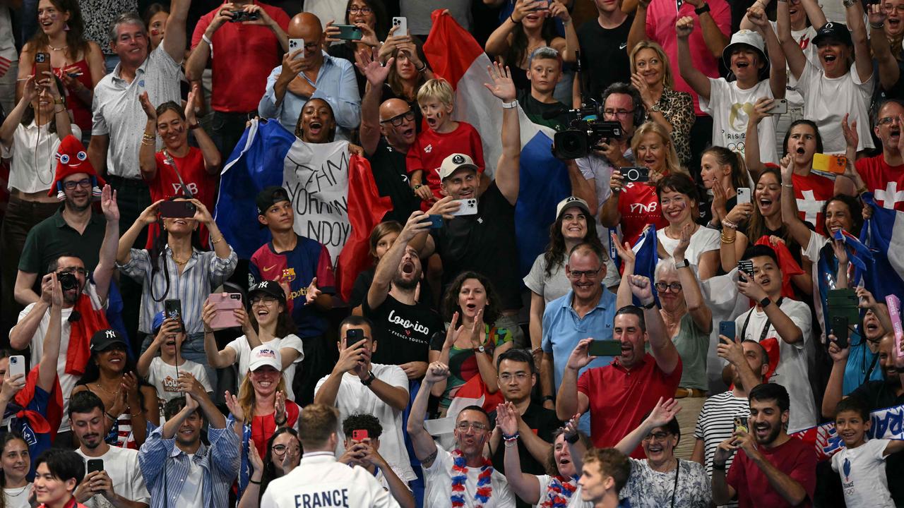 Marchand, facing the crowd bottom centre, celebrated with supporters after his win. Picture: Jonathan Nackstrand/AFP