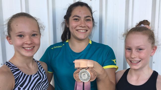 Moreton Bay College past student Georgia Godwin with Lucy White of Ascot and Grace Webb of Eatons Hill at Delta Gymnastics, Kedron