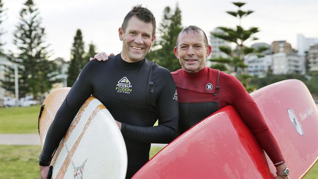 Tony Abbott and Mike Baird have a surf the day before the election at North Steyne. Picture: Braden Fastier