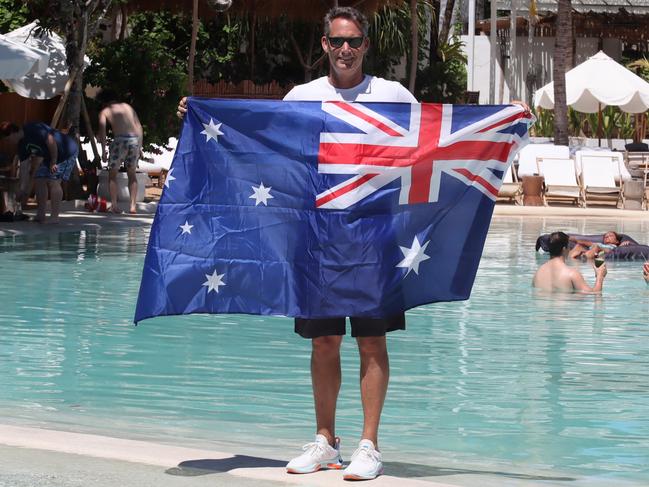 Andrew Stanway holding the Australian flag in the pool of his Mrs Sippy Restaurant in Seminyak, Bali. Picture: Lukman S.Bintoro