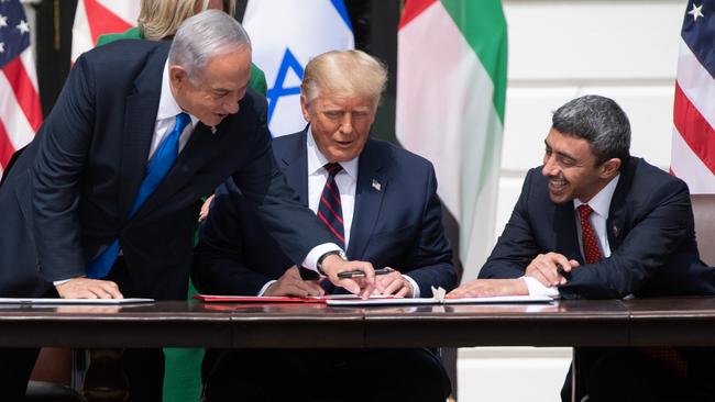 Israeli Prime Minister Benjamin Netanyahu (L), Donald Trump, and UAE Foreign Minister Abdullah bin Zayed Al-Nahyan (R) participate in the signing of the Abraham Accords. Picture: AFP.