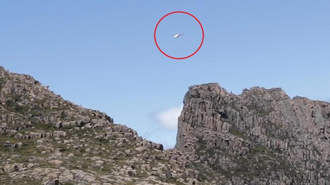 A helicopter flies low over Tasmania's World Heritage wilderness at Mt Geryon in the Du Cane Range near the famous Overland Track. Picture: Supplied