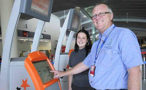 Inspecting one of Jetstar’s new DIY check-in kiosks at the Ballina-Byron Gateway Airport are airport operations manager Graeme Gordon and office administrator Sam McGrath. . Picture: Doug Eaton